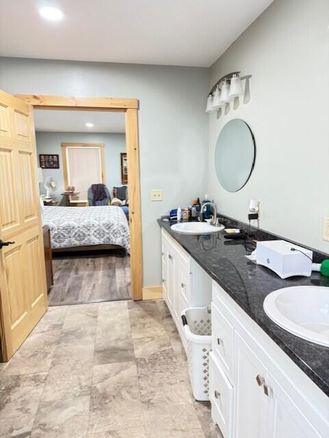 1027 Gardner Creek Rd, Wade, ME 04786 - bathroom featuring double vanity, connected bathroom, and recessed lighting