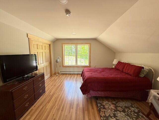 1027 Gardner Creek Rd, Wade, ME 04786 - bedroom featuring light wood finished floors, lofted ceiling, and a baseboard radiator