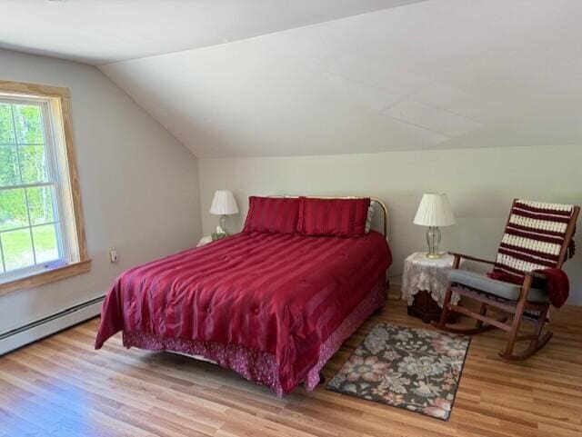 1027 Gardner Creek Rd, Wade, ME 04786 - bedroom featuring wood finished floors, lofted ceiling, and baseboard heating
