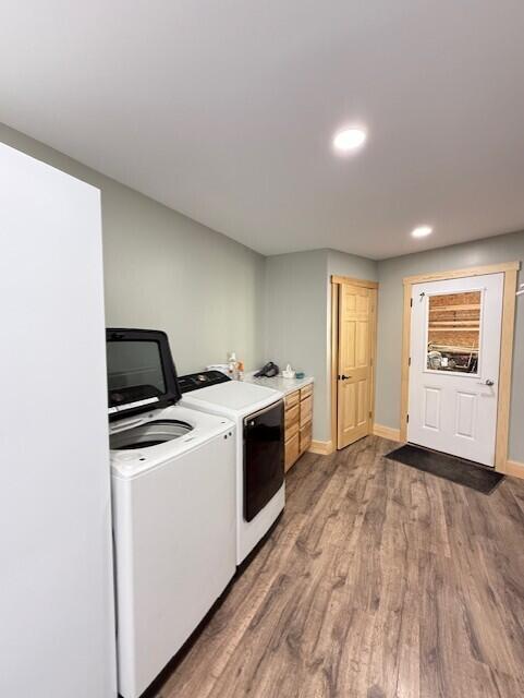 1027 Gardner Creek Rd, Wade, ME 04786 - laundry area featuring cabinet space, washing machine and dryer, wood finished floors, and recessed lighting