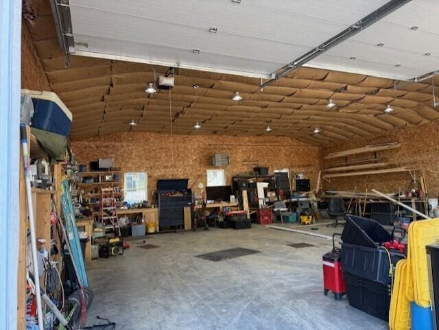 1027 Gardner Creek Rd, Wade, ME 04786 - garage featuring a workshop area and a garage door opener