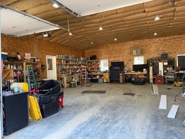 1027 Gardner Creek Rd, Wade, ME 04786 - garage featuring a workshop area and a garage door opener