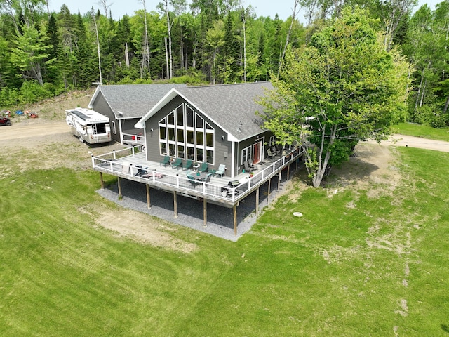 1027 Gardner Creek Rd, Wade, ME 04786 - rear view of property with a shingled roof, a wooden deck, a yard, and a view of trees