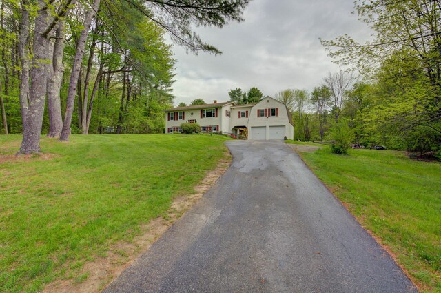 74 Spear Rd, Standish, ME 04084 - split foyer home with a garage, asphalt driveway, and a front yard