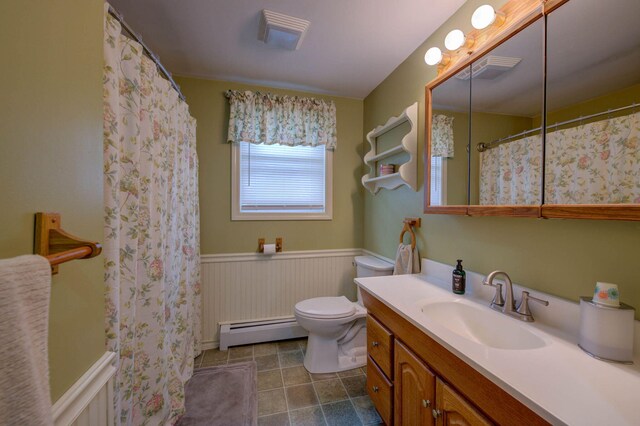 74 Spear Rd, Standish, ME 04084 - bathroom featuring baseboard heating, a wainscoted wall, toilet, vanity, and tile patterned flooring