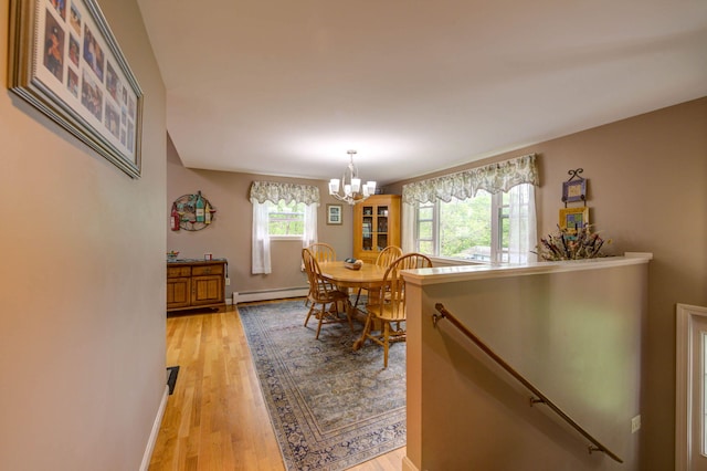 74 Spear Rd, Standish, ME 04084 - dining room with baseboard heating, a chandelier, light wood-type flooring, and baseboards