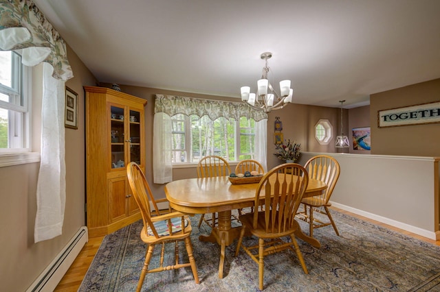 74 Spear Rd, Standish, ME 04084 - dining room with a baseboard radiator, a chandelier, light wood finished floors, baseboards, and a baseboard heating unit