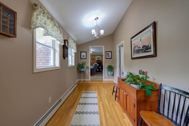 74 Spear Rd, Standish, ME 04084 - hallway with a baseboard radiator, light wood-style flooring, a chandelier, healthy amount of natural light, and vaulted ceiling
