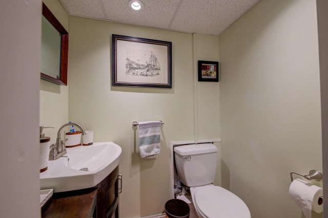 74 Spear Rd, Standish, ME 04084 - half bathroom featuring a paneled ceiling, toilet, vanity, and baseboards