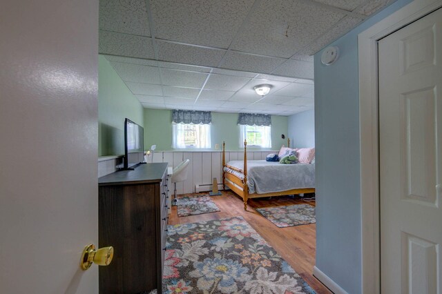 74 Spear Rd, Standish, ME 04084 - bedroom with a paneled ceiling, wood finished floors, and a baseboard heating unit