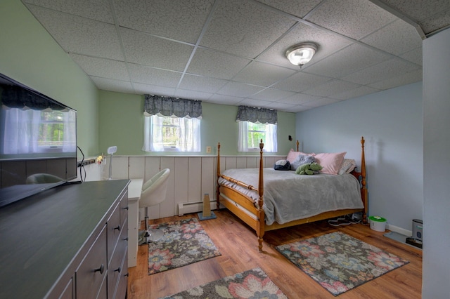 74 Spear Rd, Standish, ME 04084 - bedroom with a baseboard radiator, a drop ceiling, and wood finished floors
