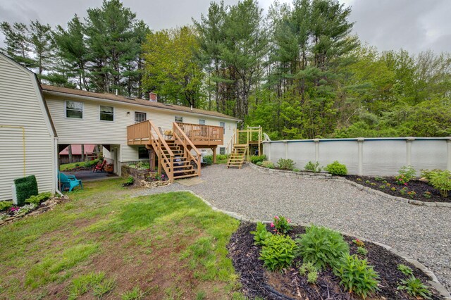 74 Spear Rd, Standish, ME 04084 - rear view of house featuring stairway, a deck, an outdoor pool, view of scattered trees, and a lawn