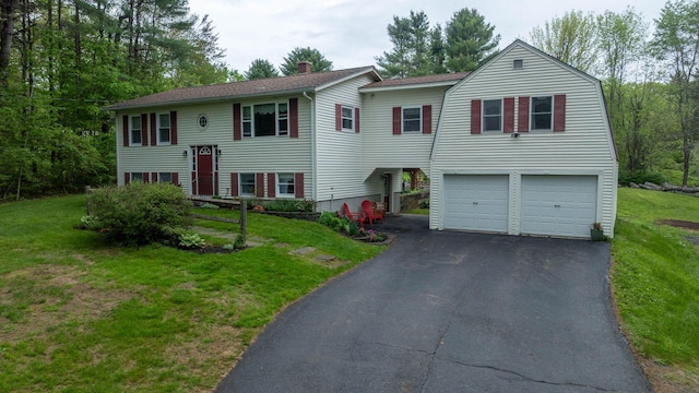 74 Spear Rd, Standish, ME 04084 - split foyer home featuring driveway, a chimney, a garage, a front yard, and roof with shingles