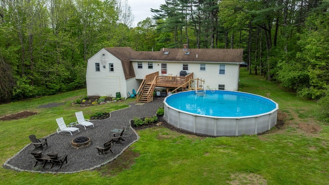 74 Spear Rd, Standish, ME 04084 - rear view of property featuring stairs, an outdoor fire pit, a wooden deck, and a lawn