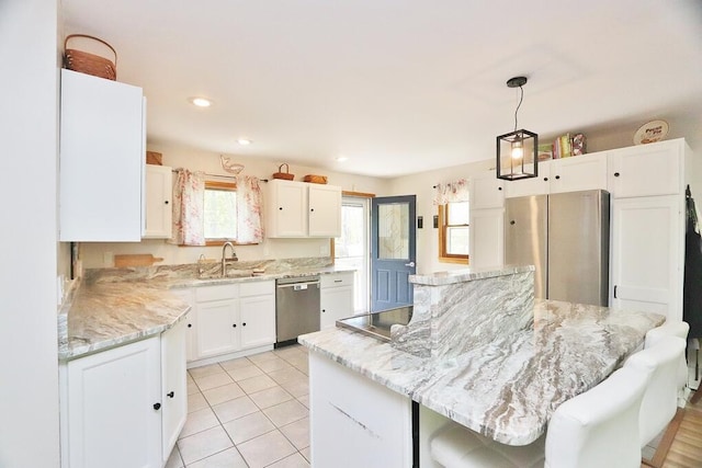 387 Nicolin Rd, Ellsworth, ME 04605 - kitchen with stainless steel appliances, a sink, white cabinets, and a kitchen island