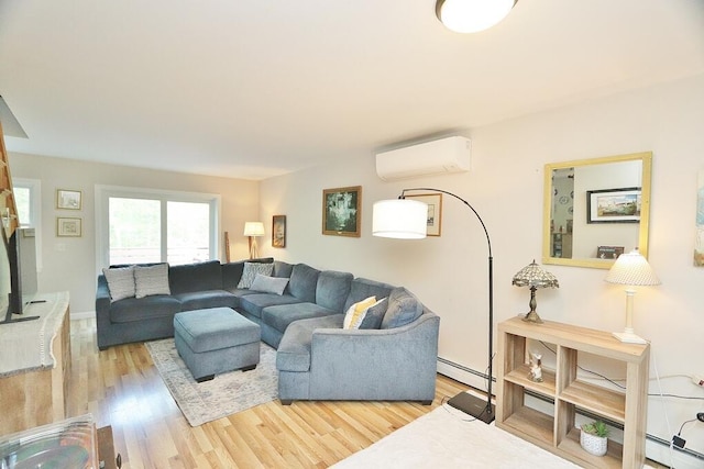 387 Nicolin Rd, Ellsworth, ME 04605 - living room featuring a wall mounted AC, light wood-style floors, and a baseboard heating unit