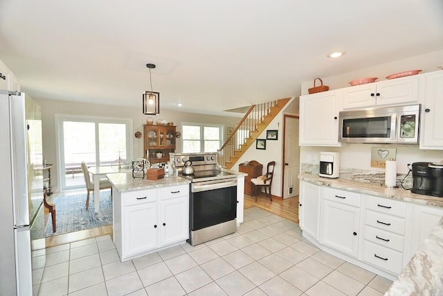 387 Nicolin Rd, Ellsworth, ME 04605 - kitchen with appliances with stainless steel finishes, white cabinetry, pendant lighting, light tile patterned floors, and recessed lighting