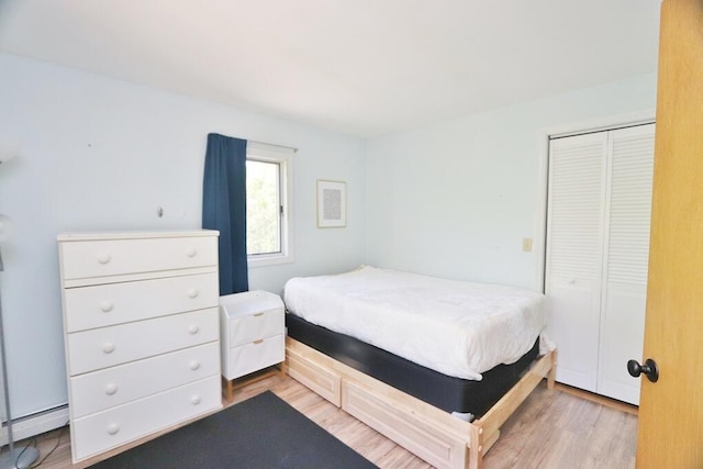 387 Nicolin Rd, Ellsworth, ME 04605 - bedroom featuring a baseboard heating unit, light wood-type flooring, and a closet