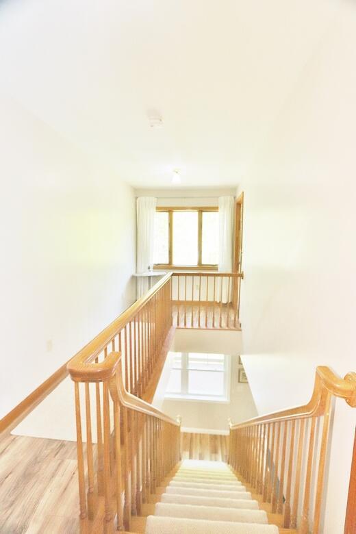387 Nicolin Rd, Ellsworth, ME 04605 - staircase with wood finished floors, plenty of natural light, and baseboards