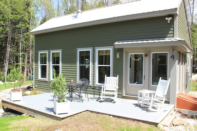 382 Riverbend Rd, Brownfield, ME 04010 - rear view of property with metal roof, a deck, and outdoor dining area