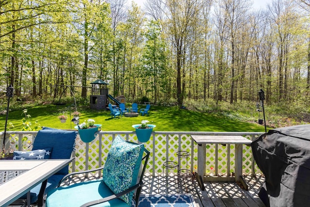 188 Boothbay Rd, Edgecomb, ME 04556 - wooden terrace with an outdoor fire pit, outdoor dining area, a lawn, a grill, and a playground