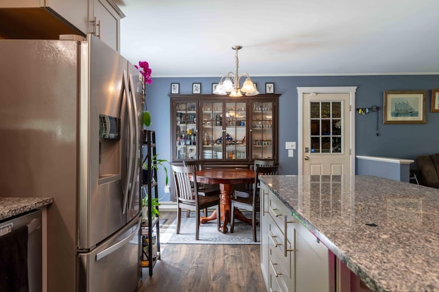 188 Boothbay Rd, Edgecomb, ME 04556 - kitchen featuring appliances with stainless steel finishes, a chandelier, dark wood-type flooring, decorative light fixtures, and dark stone counters