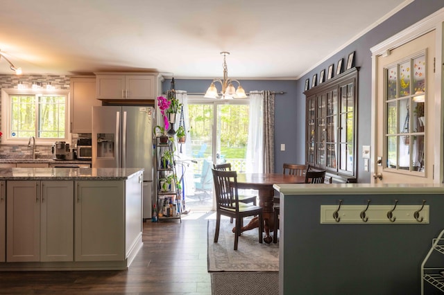 188 Boothbay Rd, Edgecomb, ME 04556 - kitchen with stainless steel fridge, plenty of natural light, a chandelier, dark wood-style flooring, and crown molding
