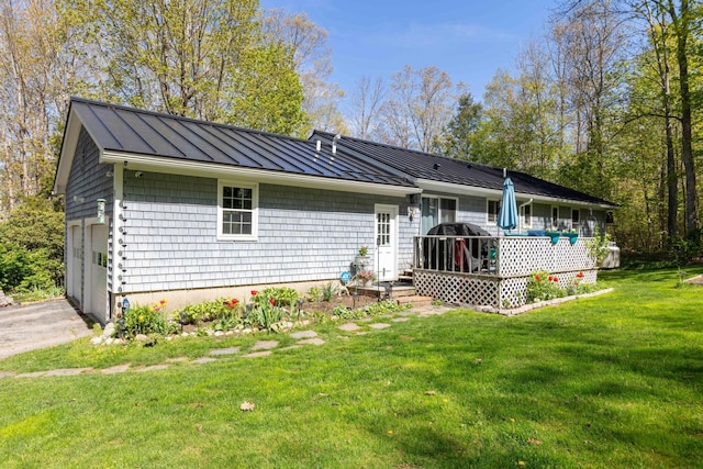 188 Boothbay Rd, Edgecomb, ME 04556 - rear view of house with a standing seam roof, a metal roof, and a lawn