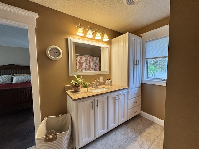 10 Goulet St, Lewiston, ME 04240 - ensuite bathroom with vanity and baseboards