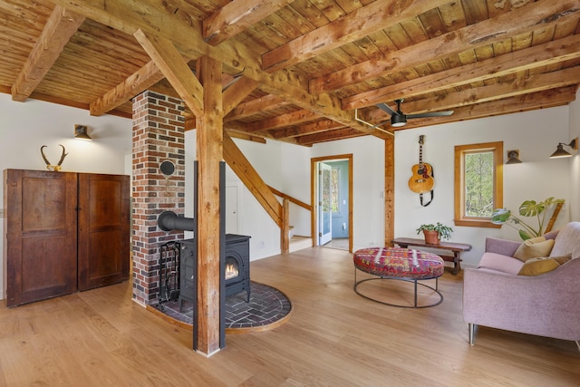 121 Heal Rd, Lincolnville, ME 04849 - living room featuring wood ceiling, beamed ceiling, wood finished floors, and a wood stove