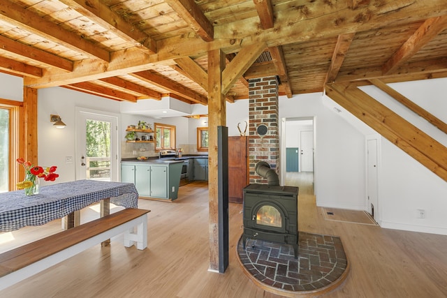 121 Heal Rd, Lincolnville, ME 04849 - living room featuring a wood stove, light wood-style flooring, beam ceiling, and wooden ceiling