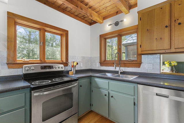 121 Heal Rd, Lincolnville, ME 04849 - kitchen featuring stainless steel appliances, wooden ceiling, a sink, dark countertops, and beam ceiling