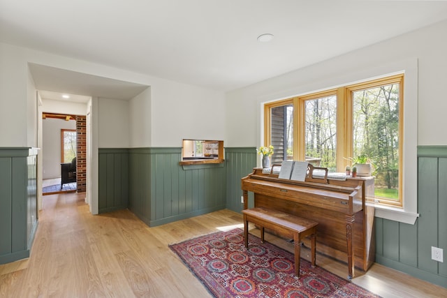 121 Heal Rd, Lincolnville, ME 04849 - sitting room with a wainscoted wall and light wood finished floors
