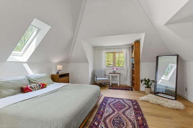 121 Heal Rd, Lincolnville, ME 04849 - bedroom featuring a skylight, lofted ceiling, and wood finished floors