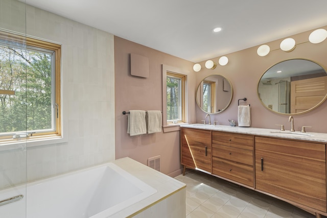 121 Heal Rd, Lincolnville, ME 04849 - bathroom featuring tile patterned floors, a tub to relax in, double vanity, and recessed lighting