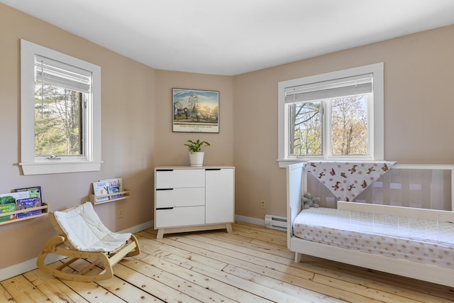 121 Heal Rd, Lincolnville, ME 04849 - living area featuring healthy amount of natural light, light wood finished floors, and a baseboard heating unit