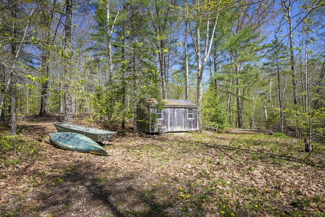 121 Heal Rd, Lincolnville, ME 04849 - view of yard featuring a storage shed, an outbuilding, and a wooded view