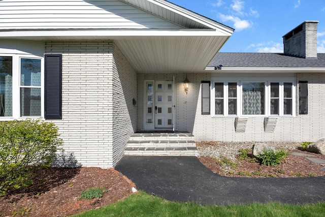 164 Dewitt Ave, Bangor, ME 04401 - view of exterior entry with brick siding and a chimney