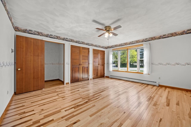 164 Dewitt Ave, Bangor, ME 04401 - unfurnished bedroom featuring baseboard heating, light wood-type flooring, multiple closets, baseboards, and ceiling fan