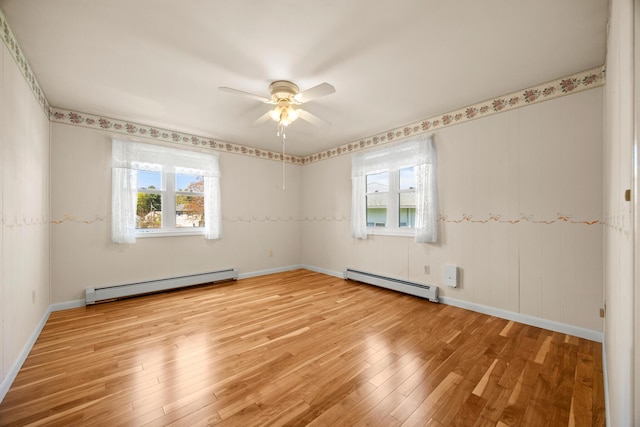 164 Dewitt Ave, Bangor, ME 04401 - empty room with baseboard heating, light wood-style flooring, and healthy amount of natural light