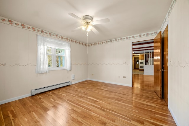 164 Dewitt Ave, Bangor, ME 04401 - spare room featuring a baseboard heating unit, light wood-style floors, a ceiling fan, and baseboards