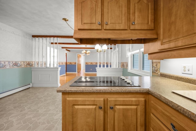 164 Dewitt Ave, Bangor, ME 04401 - kitchen with black electric cooktop, a chandelier, a peninsula, light stone finish floors, and brown cabinets