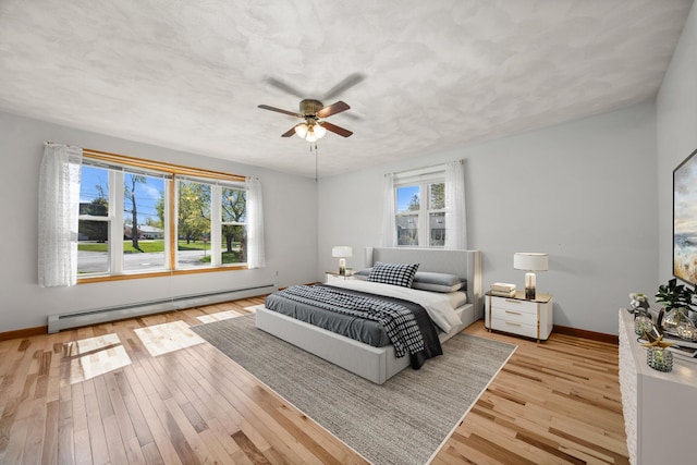 164 Dewitt Ave, Bangor, ME 04401 - bedroom with a baseboard heating unit, multiple windows, and wood finished floors