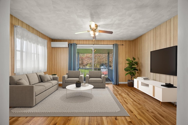 164 Dewitt Ave, Bangor, ME 04401 - living area featuring ceiling fan, wood walls, wood finished floors, and baseboards