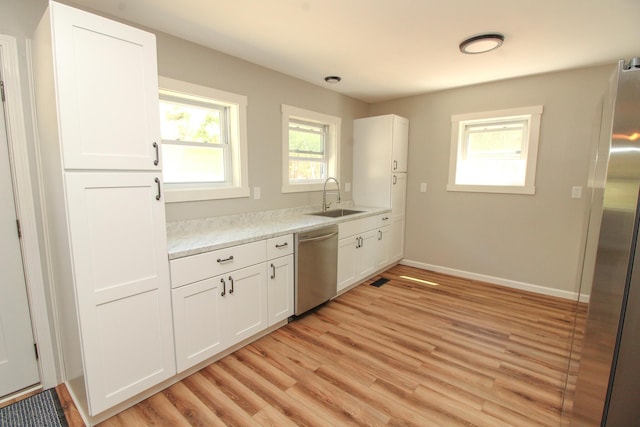 342 Spring Bridge Rd, Greenbush, ME 04418 - kitchen with appliances with stainless steel finishes, a sink, light countertops, and white cabinetry
