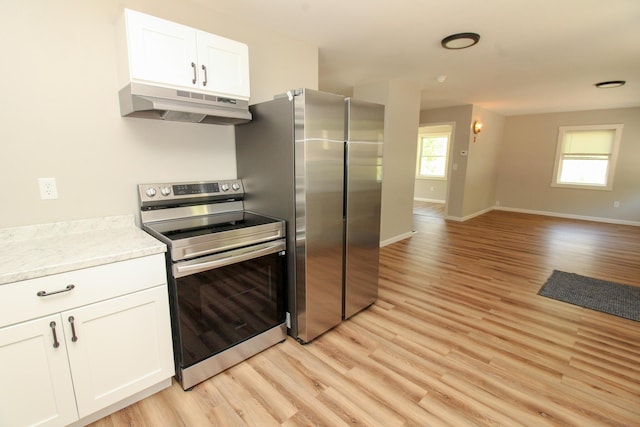 342 Spring Bridge Rd, Greenbush, ME 04418 - kitchen featuring under cabinet range hood, appliances with stainless steel finishes, light wood-style flooring, open floor plan, and white cabinets