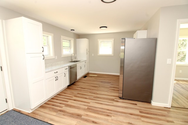 342 Spring Bridge Rd, Greenbush, ME 04418 - kitchen featuring appliances with stainless steel finishes, a sink, baseboards, and white cabinets