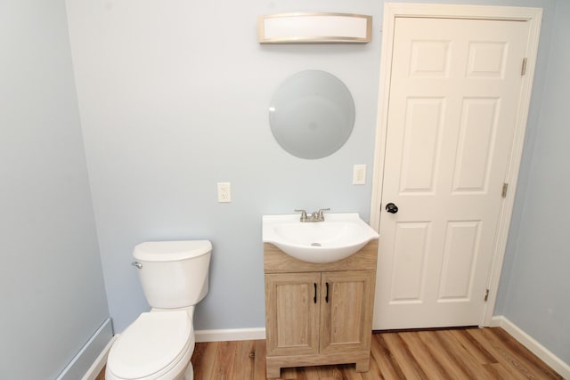 342 Spring Bridge Rd, Greenbush, ME 04418 - half bathroom with wood finished floors, vanity, toilet, and baseboards