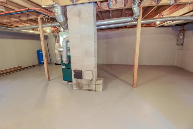 342 Spring Bridge Rd, Greenbush, ME 04418 - unfinished below grade area with electric panel, a water pressure tank, and electric water heater