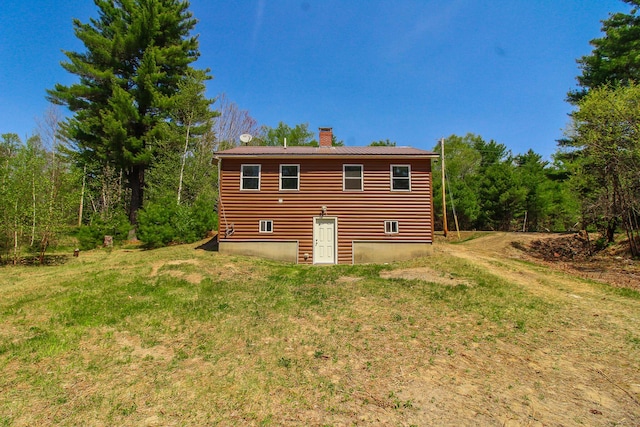 342 Spring Bridge Rd, Greenbush, ME 04418 - back of property with a chimney and faux log siding